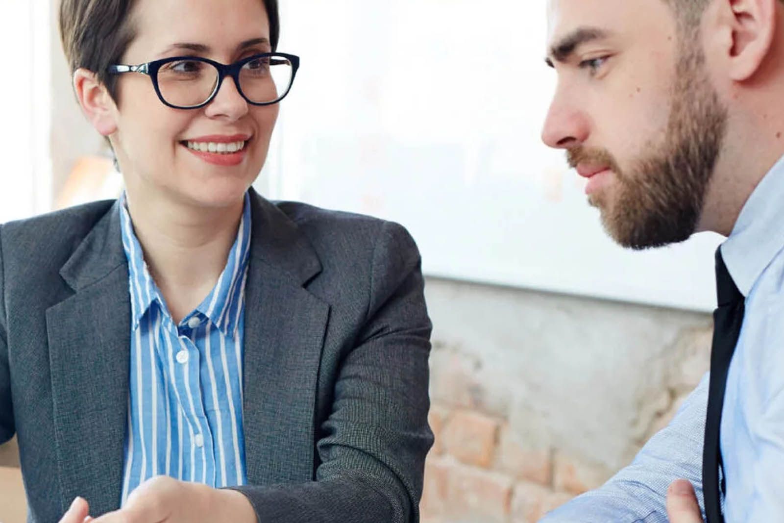 a smart male and female discussing business